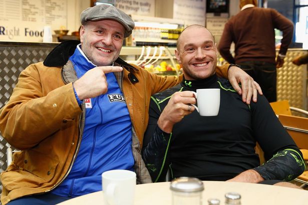 Tyson Fury with father John Fury relax in the cafe before a media workout at the Peacock Gym