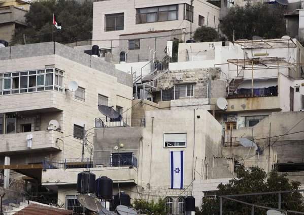 An Israeli flag hangs on a building in the Silwan neighborhood of East Jerusalem that was taken over by settlers after Palestinian families were evicted