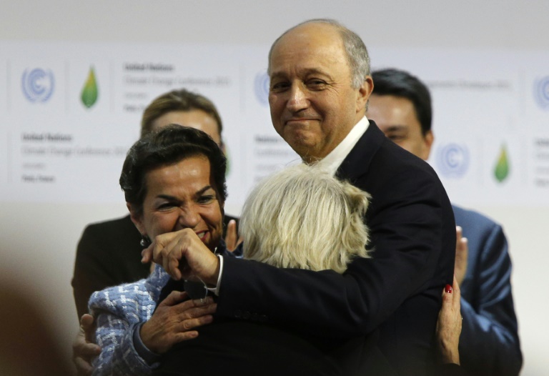 AFP  Francois Guillot French Foreign Minister Laurent Fabius hugs French Ambassador for COP21 Laurence Tubiana as Executive Secretary of the UNFCCC Christiana Figueres looks on in Le Bourget