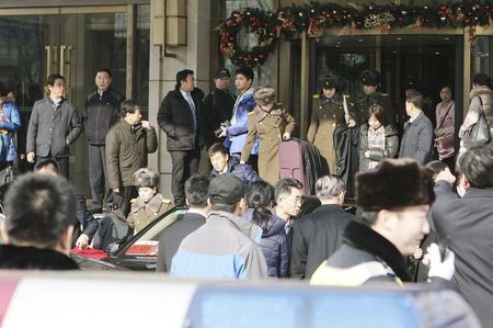 Members of the Moranbong Band of North Korea walks out of a hotel with their instruments and luggage in central Beijing China