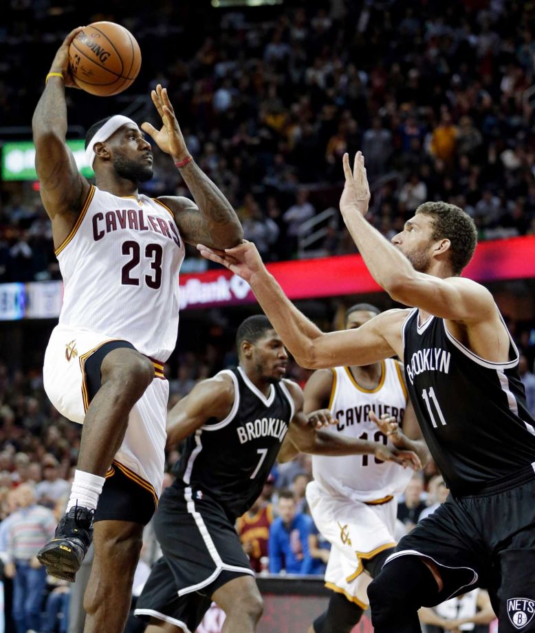 Cleveland Cavaliers Le Bron James shoots toward the basket against Brooklyn Nets’ Brook Lopez in the second half of an NBA basketball game Saturday Nov. 28 2015 in Cleveland. The Cavaliers won 90-88