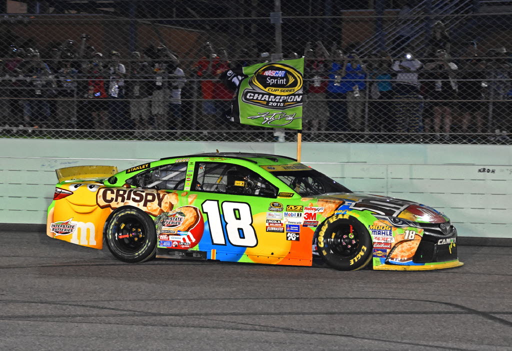 Sprint Cup champion Kyle Busch carries victory flag down frontsretch