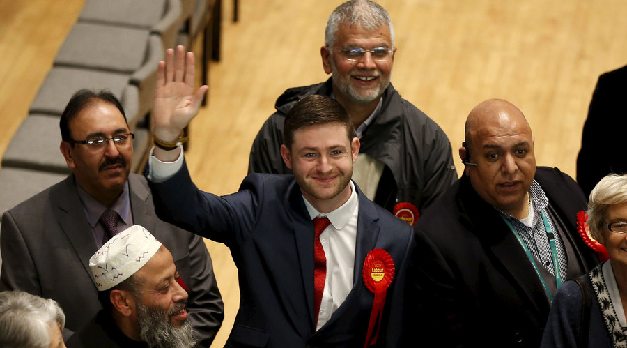 Labour Party candidate Jim Mc Mahon waves after arriving at the count for the Oldham West and Royton by-election at the Civic Centre in Oldham northern England