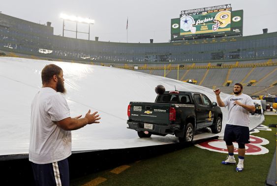 Frederick left and Zack Martin warm up before the tarp is taken off Lambeau Field before an NFL football game against the Green Bay Packers Sunday Dec. 13 2015 in Green Bay Wis