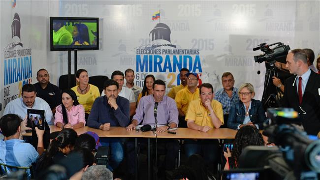 Miranda State governor and opposition leader Henrique Capriles Radonski speaks next to newly-elected deputies of the National Assembly during a press conference in the Venezuelan capital Caracas