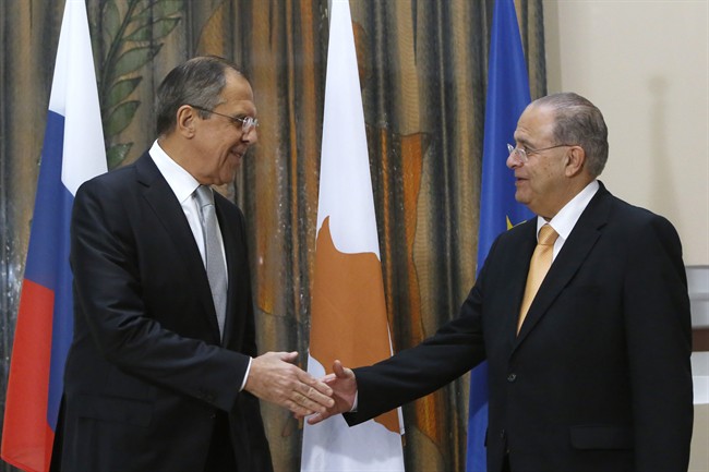 Russian Foreign Minister Sergey Lavrov left and Cypriot Foreign Minister Ioannis Kasoulides shake hands before their talks at the foreign ministry house in Nicosia on Wednesday Dec. 2 2015