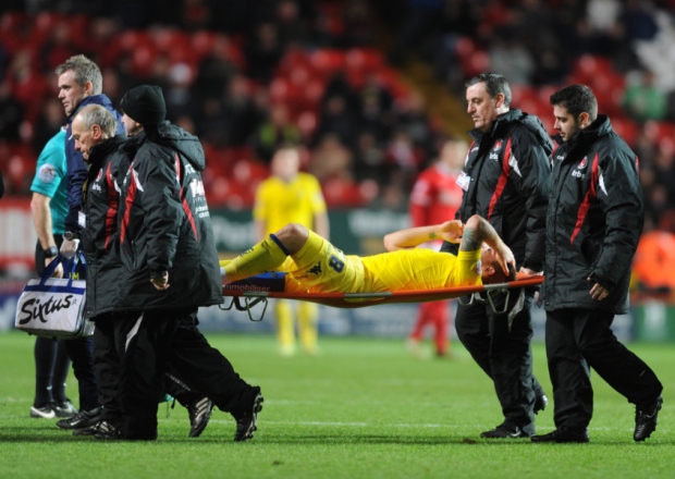 Leeds United's Gaetano Berardi is stretchered off the pitch at Charlton and now looks to be out for two months