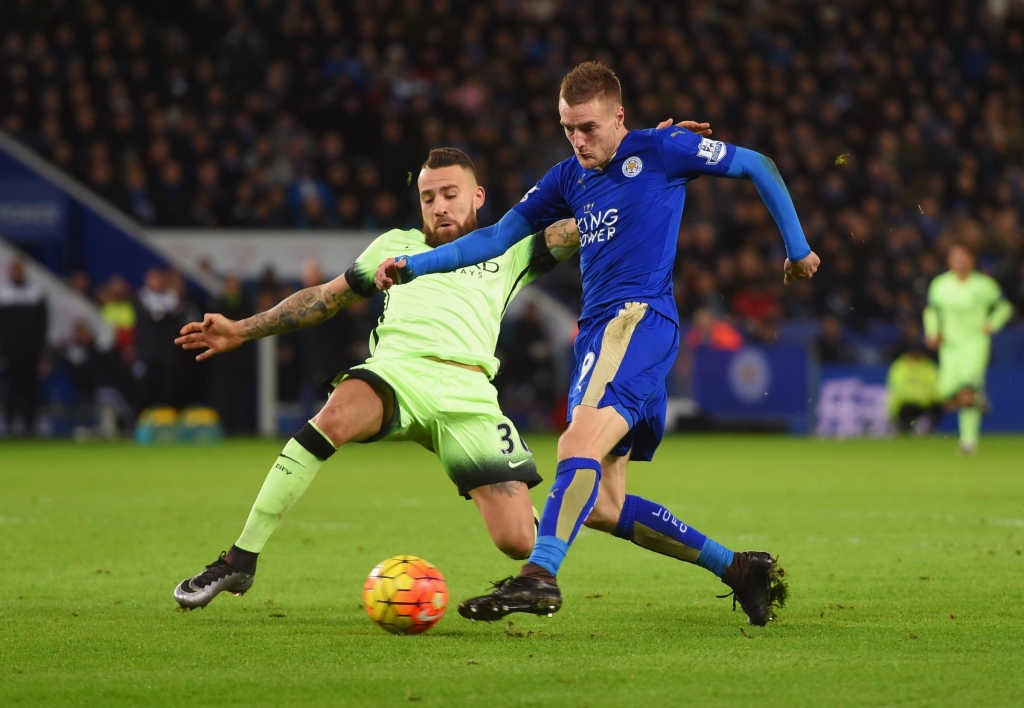 LEICESTER ENGLAND- DECEMBER 29 Jamie Vardy of Leicester City is challenged by Nicolas Otamendi of Manchester City as he shoots during the Barclays Premier League match between Leicester City and Manchester City at The King Power Stadium on December 29