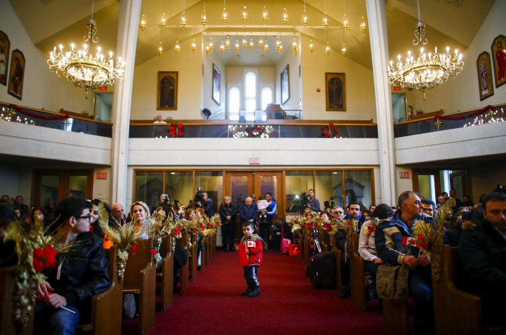 REFILE- CORRECTING CITY Syrian refugee Levon Kourken 4 stands on an aisle during a welcoming service for Syrian refugees at St. Mary Armenian Apostolic Church at the Armenian Community Centre of Toronto in Toronto