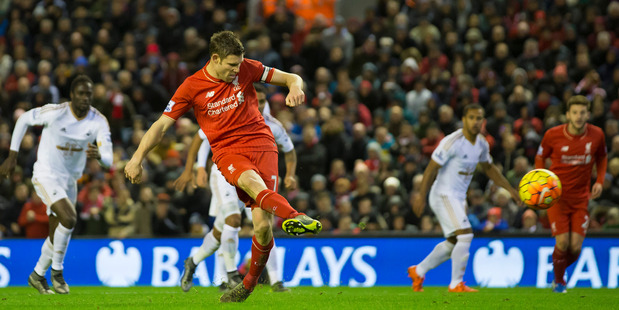 Liverpool's James Milner scores a penalty during the English Premier League match between Liverpool and Swansea