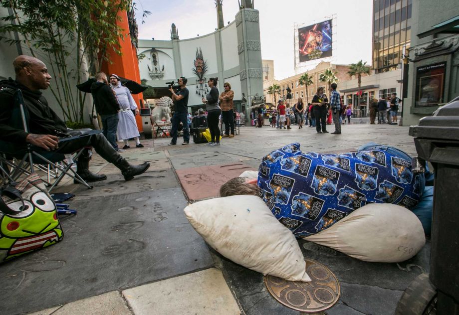 'Star Wars fans Deuce Wayne from Virginia left and Larry Ross from La Crescenta Calif. right rest while waiting in line up outside the TCL Chinese Theater Imax for the'Star Wars The Force Awakens premiere