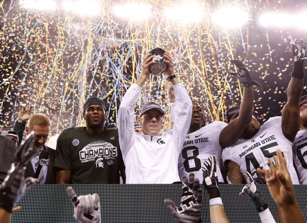 Dec 5 2015 Indianapolis IN USA Michigan State Spartans head coach Mark Dantonio celebrates with his team after defeating the Iowa Hawkeyes in the Big Ten Conference football championship game at Lucas Oil Stadium. Mandatory Credit Brian Spurlock-USA