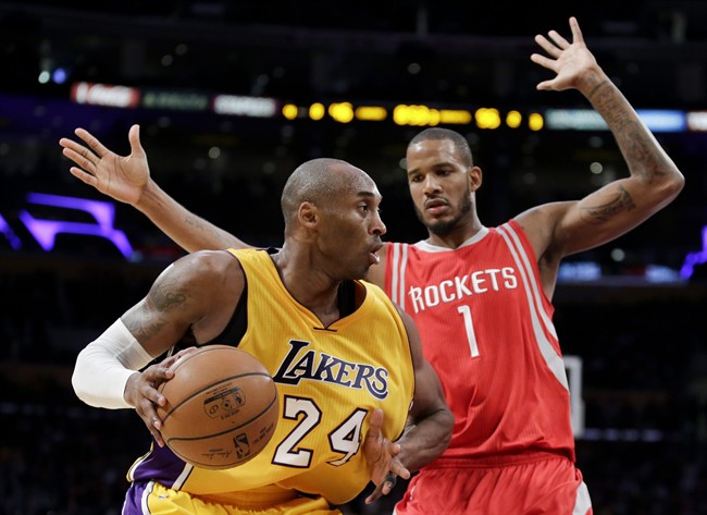 Los Angeles Lakers forward Kobe Bryant left drives around Houston Rockets forward Trevor Ariza during the second half of an NBA basketball game in Los Angeles Thursday Dec. 17 2015