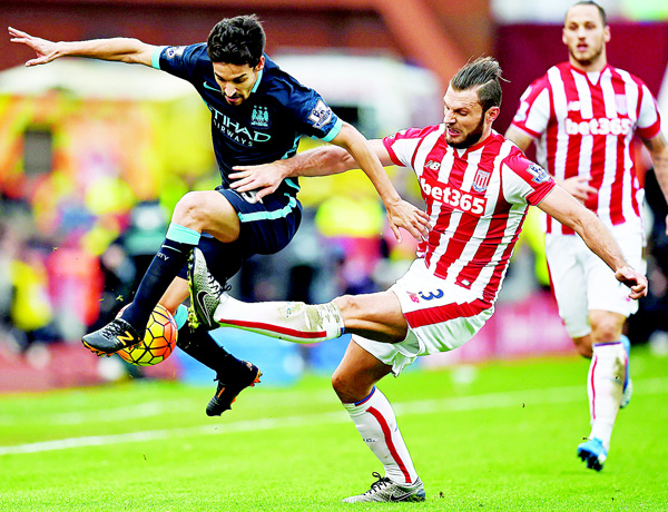 Manchester City’s Spanish midfielder Jesus Navas, vies with Stoke City’s Dutch defender Erik Pieters during the English Premier League football match between Stoke City and Manchester City at the Britannia Stadium in Stoke-on-Trent central Eng