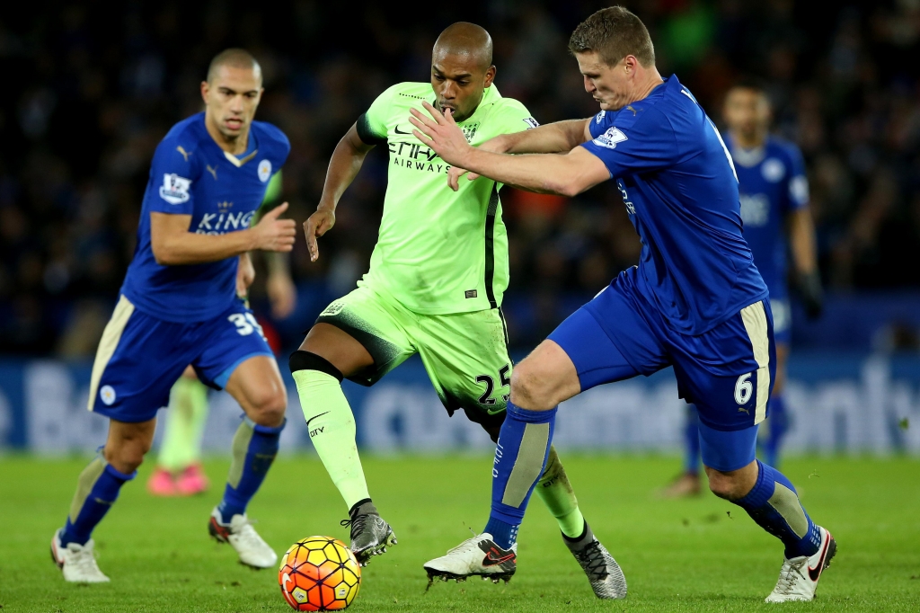 Manchester City's Fernandinho battles for the ball with Leicester City's Robert Huth