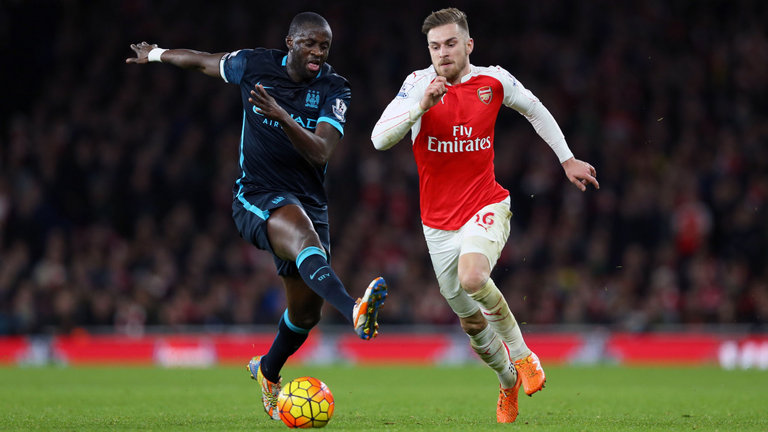 Manchester City's Yaya Toure and Arsenal's Aaron Ramsey battle for the ball at the Emirates