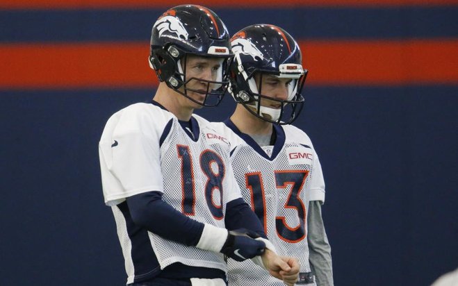 Denver Broncos quarterbacks Peyton Manning front and Trevor Siemian warm up during a practice at the team's NFL football headquarters Wednesday