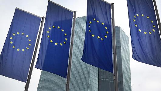 European Union flags in front of the headquarters of the European Central Bank in Frankfurt am Main Germany