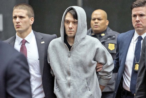 Martin Shkreli the former hedge fund manager under fire for buying a pharmaceutical company and ratcheting up the price of a life-saving drug is escorted by law enforcement agents in New York on Thursday after being taken into custody following a securi