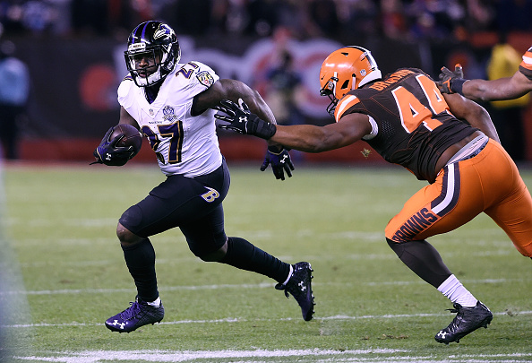 CLEVELAND OH- NOVEMBER 30 Terrance West #27 of the Baltimore Ravens gets past the defense of c #44 of the Cleveland Browns during the fourth quarter at First Energy Stadium