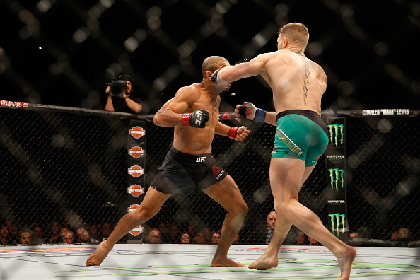 Conor Mc Gregor of Ireland punches Jose Aldo of Brazil in their UFC welterweight championship bout during the UFC 194 event inside MGM Grand Garden Arena