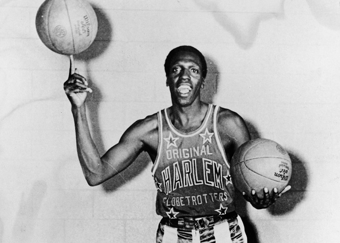 Meadowlark Lemon of the Harlem Globetrotters balances a basketball on his finger