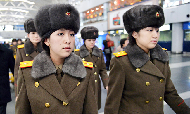 Members of North Korea's Moranbong Band arrive at an airport in Beijing to return to the North Saturday