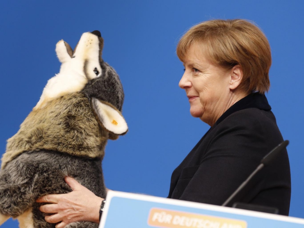 Chancellor Angela Merkel holding a toy wolf gift at a Christian Democrat convention in Karlsruhe addressed party members with a speech designed to take the bite out of her critics