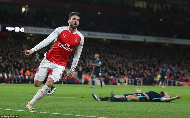 GUNNER BEAT YOU... Arsenal striker Olivier Giroud wheels away jubilantly with Manchester City defender Otamendi crestfallen as the Gunners took control of proceedings just before the break during their English Premiership match at the Emirates S