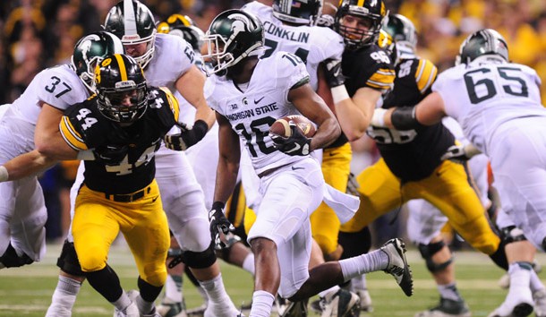 Dec 5 2015 Indianapolis IN USA Michigan State Spartans wide receiver Aaron Burbridge runs the ball as Iowa Hawkeyes linebacker Ben Niemann looks to defend during the first half in the Big Ten Conference football championship game at Lucas O