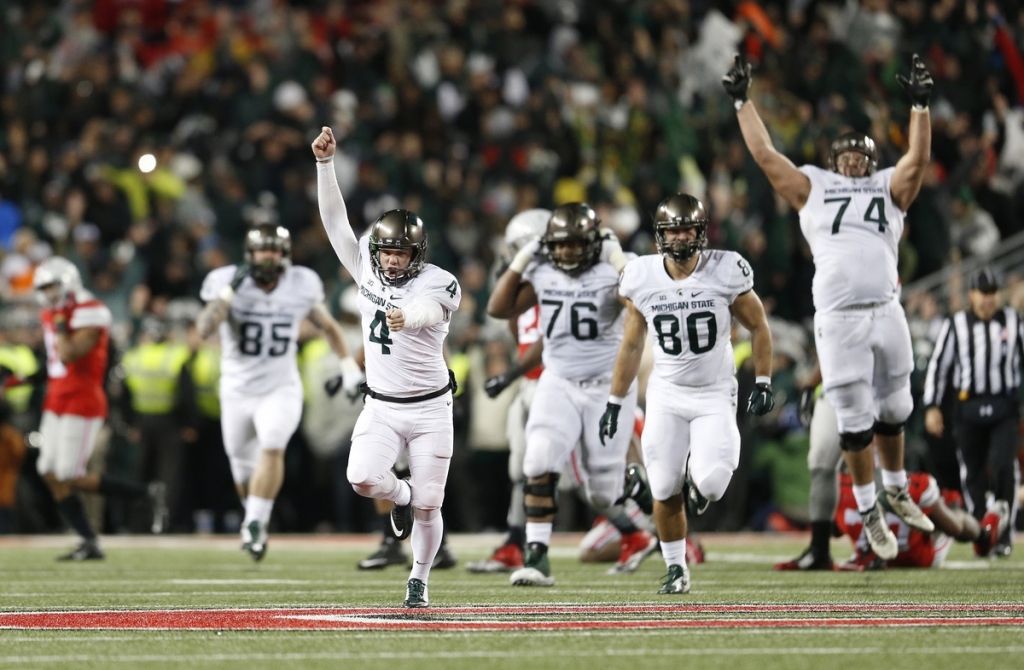 Michigan State kicker Michael Geiger runs down the field in celebration after kicking a game-winning 41-yard field goal against Ohio State as time expired in the fourth quarter of Saturday's game in Columbus Ohio. Michigan State won 17-14. (Adam Cair