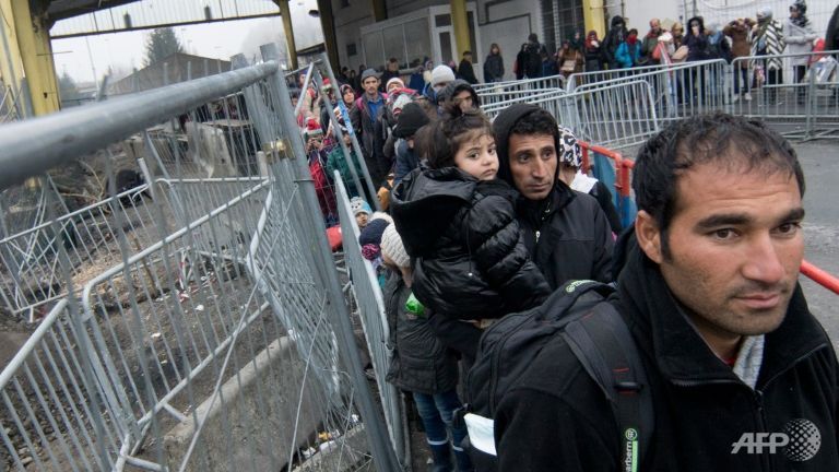 Migrants line up at a transit area between Austria and Slovenia at a border crossing in Spielfeld Austria on Dec 9 2015