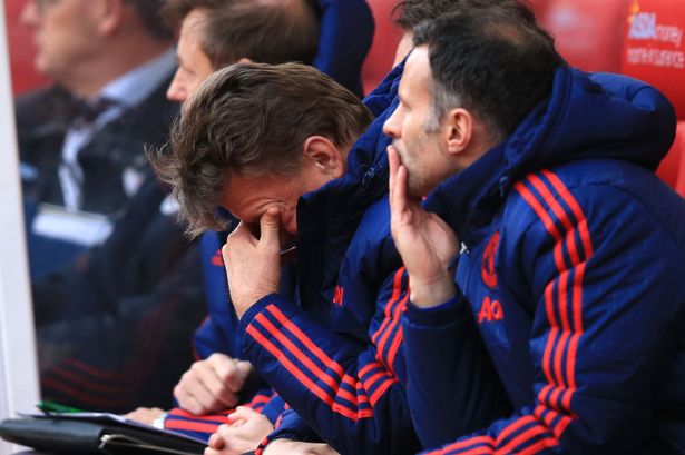 Louis van Gaal sits dejected on the bench