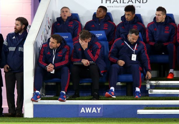 Louis van Gaal looks dejected next to Ryan Giggs and Albert Stuivenberg