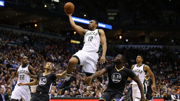 Jabari Parker #12 of the Milwaukee Bucks drives to the hoop for two points during the third quarter against the Golden State Warriors during the third quarter against the Milwaukee Bucks at BMO Harris Bradley Center in Milwaukee Wisconsin