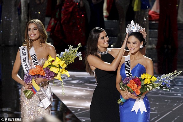 Miss Colombia, who was crowned Miss Universe 2015 for all of two minutes in Las Vegas on Sunday smiles on as Paulina Vega, last year's winner places the crown on the head of Miss Philippines Pia Wurtzbach, after host Steve Ha