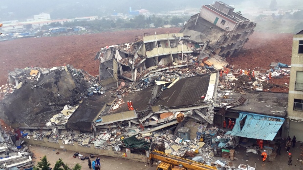 Rescuers search for survivors amongst collapsed buildings after a landslide in Shenzhen in south China's Guangdong province Sunday Dec. 20 2015