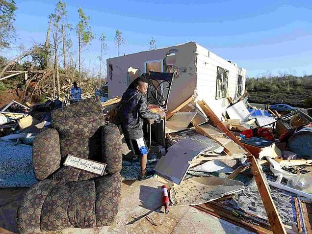 Jaquish Fox 10 helps clean up the home of his aunt Kimberly Jackson after a tornado struck Holly Springs Mississippi