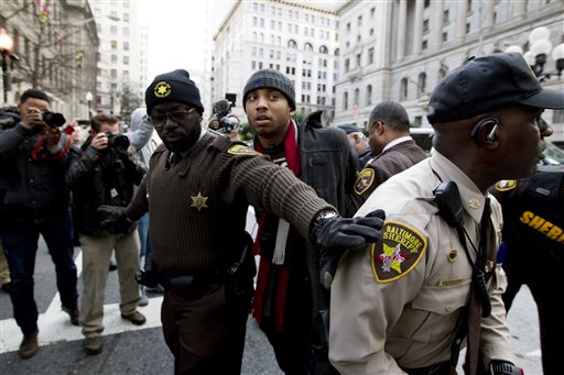 A demonstrator is arrested outside of the courthouse after a mistrial of Officer William Porter one of six Baltimore city police officers charged in connection to the death of Freddie Gray