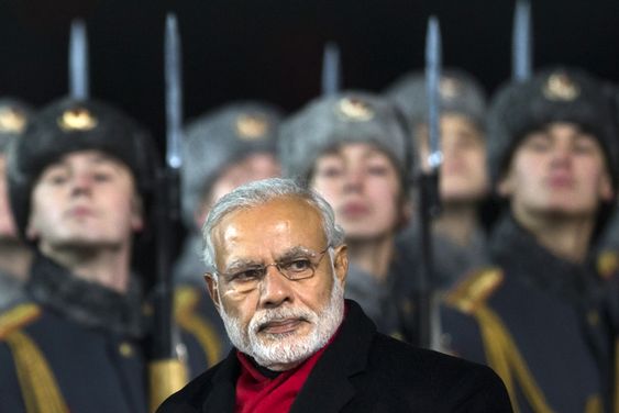 Narendra Modi walks past an honour guard upon arrival at Moscow's Government Vnukovo II Airport outside Moscow Russia Wednesday Dec. 23 2015. Modi is on official visit and plans to meet Russian President Vladimir Putini