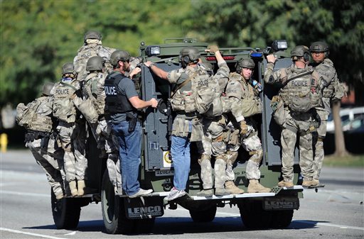 A SWAT vehicle carries police officers near the scene of a shooting in San Bernardino Calif. on Wednesday Dec. 2 2015. Police responded to reports of an active shooter at a social services facility