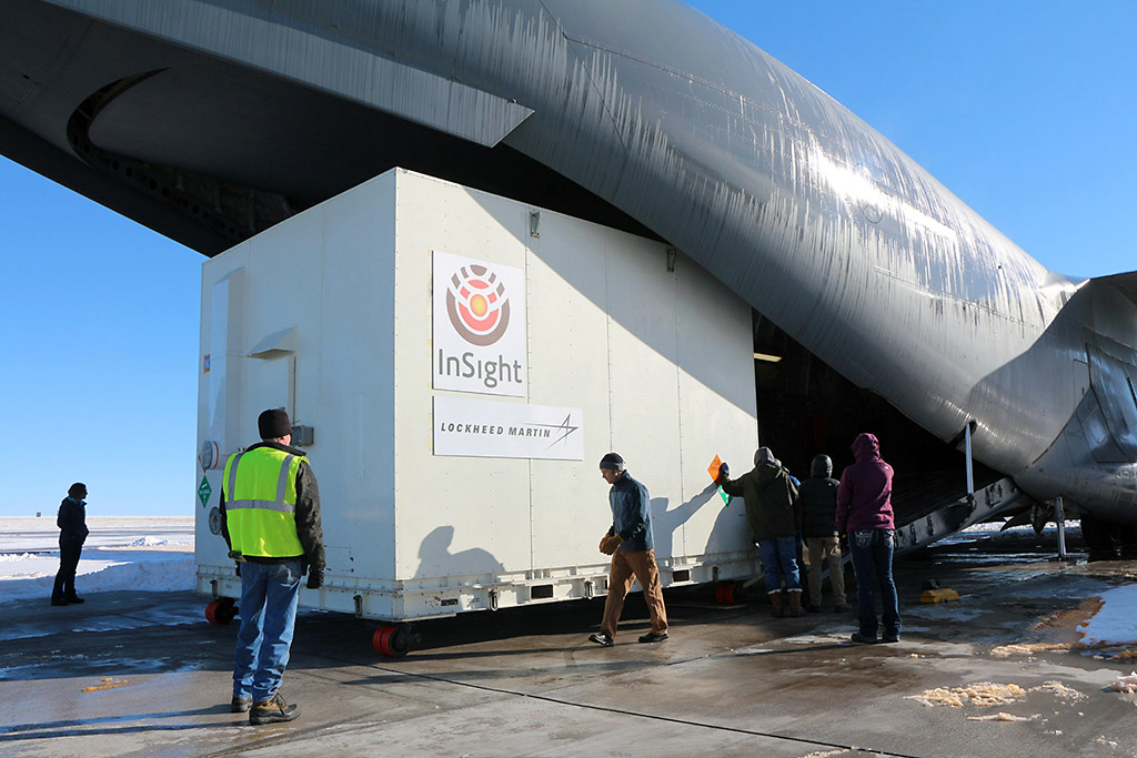 A crate containing NASA's Mars-bound In Sight spacecraft is loaded into a C-17 cargo aircraft at Buckley Air Force Base Denver for shipment to Vandenberg Air Force Base California