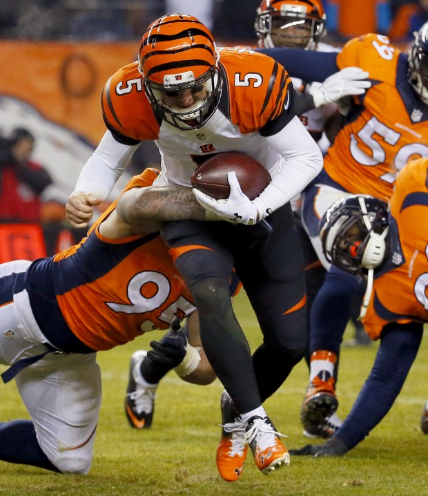 Cincinnati Bengals quarterback AJ Mc Carron is tackled by Denver Broncos defensive end Derek Wolfe during the second half of an NFL football game Monday Dec. 28 2015 in Denver