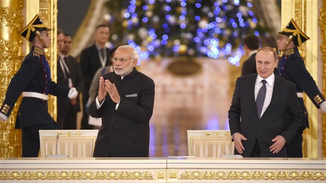 Russian President Vladimir Putin and India’s Prime Minister Narendra Modi arrive for a meeting with Russian and Indian businessmen at the Kremlin in Moscow