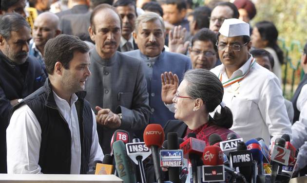 India's Congress Party president Sonia Gandhi front right and her son and party Vice President Rahul Gandhi left speak to each other before addressing media upon their arrival from a court in connection with a corruption accusation in New Delhi I