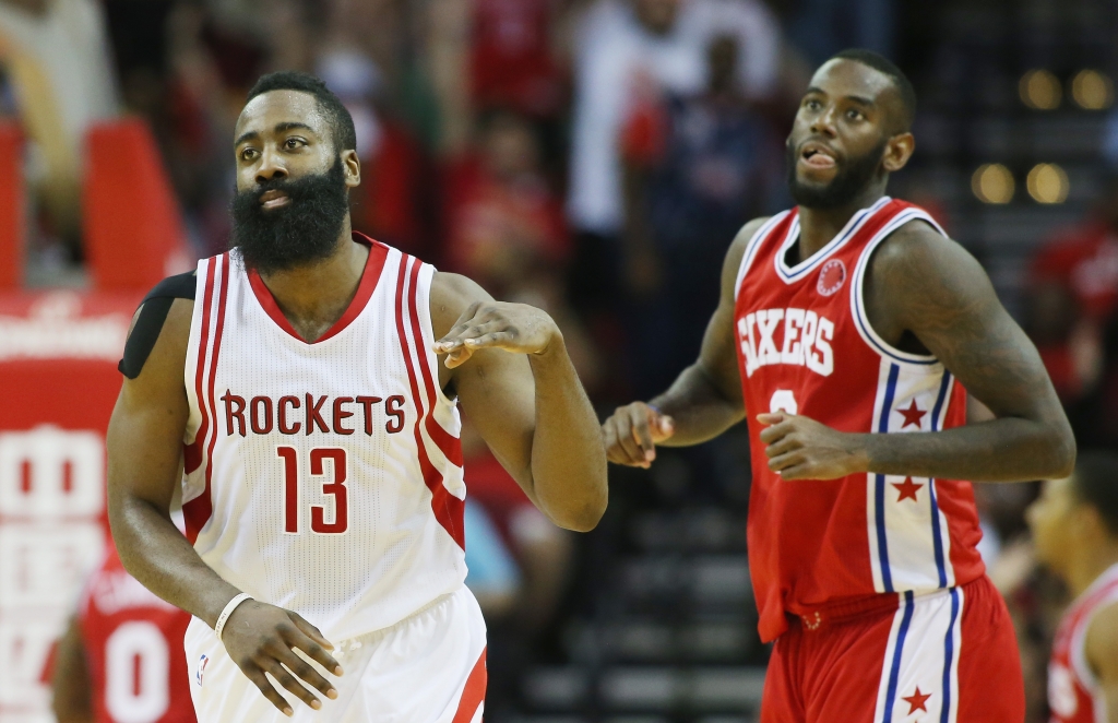 HOUSTON TX- NOVEMBER 27 James Harden #13 of the Houston Rockets celebrates after a three-point shot as Ja Karr Sampson #9 of the Philadelphia 76ers looks on during their game at the Toyota Center