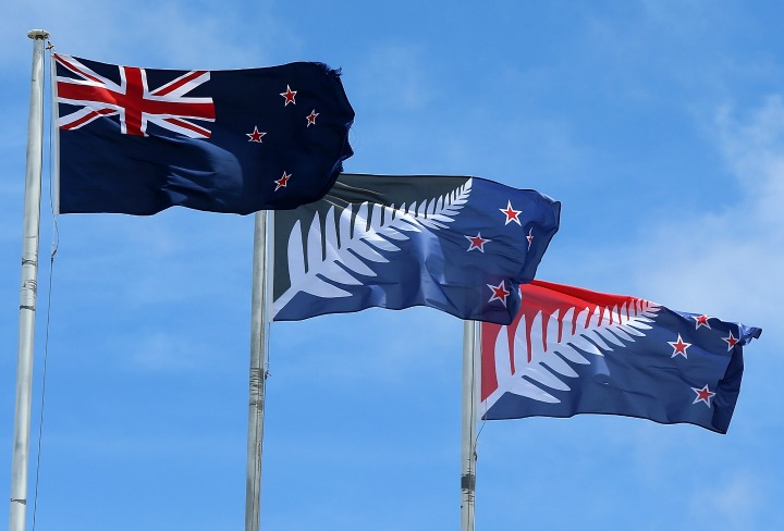 The current New Zealand flag the referendum winning blue and black Kyle Lockwood designed flag and the second placed red and blue flag fly on a building in New Lynn Auckland