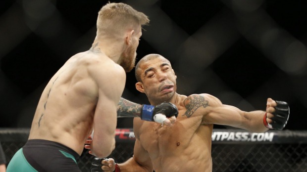 New champ Conor Mc Gregor sends Jose Aldo to the floor with a perfectly timed punch