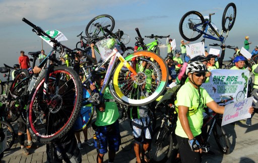 Environmentalists take part in a bicycle ride to show solidarity for the global movement for climate justice in Manila