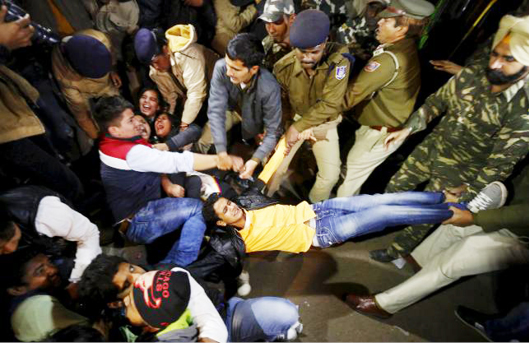 Police detain demonstrators during a protest against the release of a juvenile rape convict in New Delhi on December 20